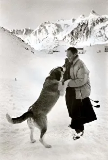 Father Bernard with Seine the St Bernand dog at St. Bernard Pass in Switzerland Father Bernard with Seine the St Bernand dog at St. Bernard Pass in Switzerland