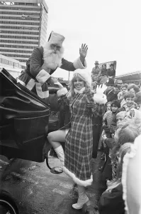 Father Christmas seen here helping his assistant into a horse drawn carriage after Father Christmas seen here helping his assistant into a horse drawn carriage after