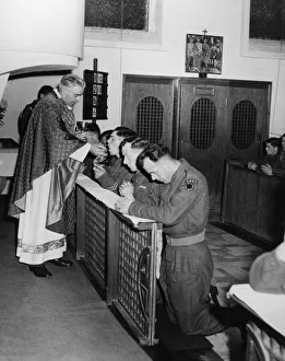 Father Devine with the British 7th Armoured Division, holds mass in a Roman Catholic Father Devine with the British 7th Armoured Division, holds mass in a Roman Catholic
