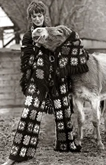 A female model wearing a matching top and trousers with patterned crocheted squares A female model wearing a matching top and trousers with patterned crocheted squares