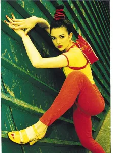 Female model wearing red denims - D & F general fashion - climbing wooden fence Female model wearing red denims - D & F general fashion - climbing wooden fence