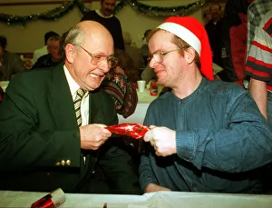 Fergus McCann pulls a cracker with Craig who Aattended a lunch for the homeless at St Fergus McCann pulls a cracker with Craig who Aattended a lunch for the homeless at St