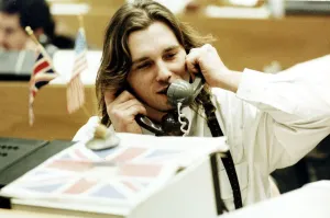 Finance Stock Exchange dealer sitting at desk Holding two telephones to each ear Finance Stock Exchange dealer sitting at desk Holding two telephones to each ear
