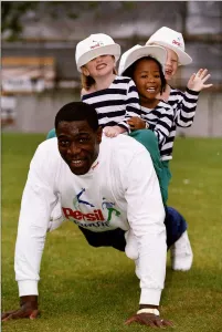 Frank Bruno boxer doing press ups with children on his back Frank Bruno boxer doing press ups with children on his back