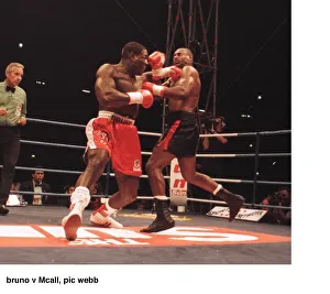 Frank Bruno lunges at Oliver McCall with a left Jab during their fight for Frank Bruno lunges at Oliver McCall with a left Jab during their fight for