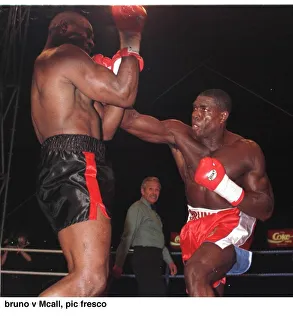 Frank Bruno strikes Oliver McCall with a right hook during their fight for Frank Bruno strikes Oliver McCall with a right hook during their fight for