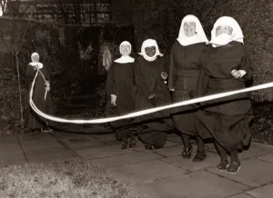 Fun loving nuns enjoying a game of skipping behind the walls of their convent Fun loving nuns enjoying a game of skipping behind the walls of their convent