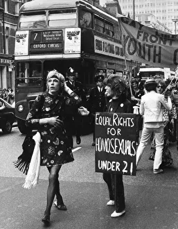 Gay Liberation March in Oxford Street Ginger a male walking past youth with placard Gay Liberation March in Oxford Street Ginger a male walking past youth with placard