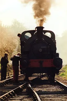 A general picture of a steam locomotive getting some attention from its engineer A general picture of a steam locomotive getting some attention from its engineer