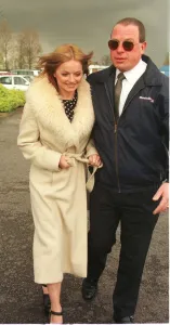 Geri Halliwell Ginger Spice in fur trimmed coat walks to the helicopter as she prepares Geri Halliwell Ginger Spice in fur trimmed coat walks to the helicopter as she prepares