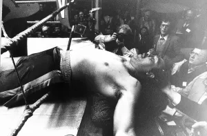 Gerrie Coetzee Boxing Heavyweight boxer lies through the bottom rope in his match against Gerrie Coetzee Boxing Heavyweight boxer lies through the bottom rope in his match against