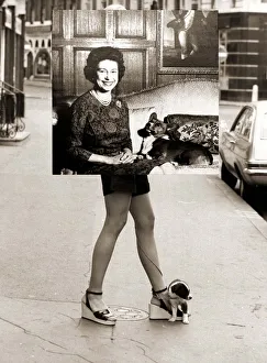 Girl wearing hotpants carrying a photograph of Queen Elizabeth to an exhibition Girl wearing hotpants carrying a photograph of Queen Elizabeth to an exhibition