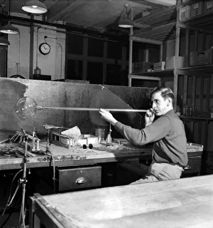 Glass blower Man blowing glass in his workshop. October 1952 C4910-001 Glass blower Man blowing glass in his workshop. October 1952 C4910-001