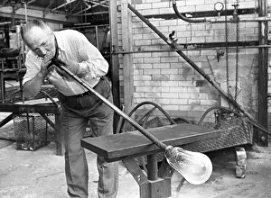 Glass blower Bill Tremble is tube drawing a glass bulb in July 1987 Glass blower Bill Tremble is tube drawing a glass bulb in July 1987