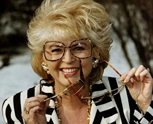 Gloria Hunniford TV Presenter holding glasses in hand voted spectacle wearer of the Year Gloria Hunniford TV Presenter holding glasses in hand voted spectacle wearer of the Year