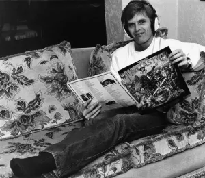 Gordon McQueen, Manchester United defender, with a copy of Elton John's album Gordon McQueen, Manchester United defender, with a copy of Elton John's album
