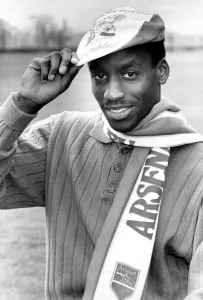Gus Caesar Football Player of Arsenal - April 1988 wearing a Arsenal Cap and Scarf Gus Caesar Football Player of Arsenal - April 1988 wearing a Arsenal Cap and Scarf
