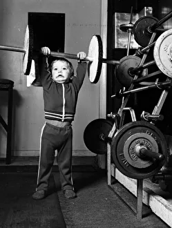 Two and half year old boy Ian Page lifts a set odf special wooden weights built for him Two and half year old boy Ian Page lifts a set odf special wooden weights built for him