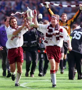 Heart of Midlothian footballer Jim Hamilton carries the Scottish Cup trophy around Celtic Heart of Midlothian footballer Jim Hamilton carries the Scottish Cup trophy around Celtic