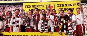 Heart of Midlothian footballers celebrate with the Scottish Cup trophy after defeating Heart of Midlothian footballers celebrate with the Scottish Cup trophy after defeating