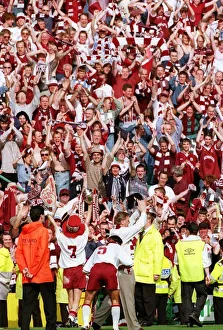 Heart of Midlothian footballers show off the Scottish Cup trophy to jubilant fans on a Heart of Midlothian footballers show off the Scottish Cup trophy to jubilant fans on a