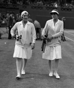Helen Wills walks out on to the court at the Wimbledon tennis championships with her Helen Wills walks out on to the court at the Wimbledon tennis championships with her