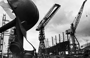 A helmet hanging with welders goggles amongst the empty cranes after the closure of Govan A helmet hanging with welders goggles amongst the empty cranes after the closure of Govan