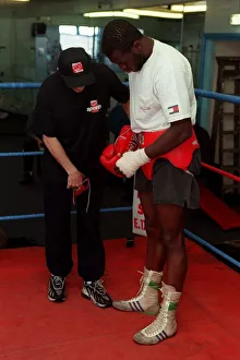 Herbie Hide Boxer putting on boxing gloves with his trainner Jim Mcdonnell Herbie Hide Boxer putting on boxing gloves with his trainner Jim Mcdonnell