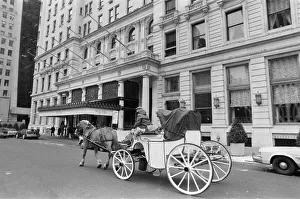 A horse drawn carriage riding past The Plaza Hotel. New York, 13th February 1981 A horse drawn carriage riding past The Plaza Hotel. New York, 13th February 1981
