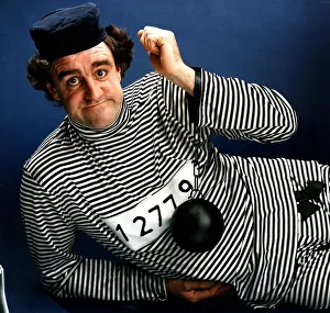 Iain McColl actor dressed as convict in striped suit ball and chain on wrist Iain McColl actor dressed as convict in striped suit ball and chain on wrist