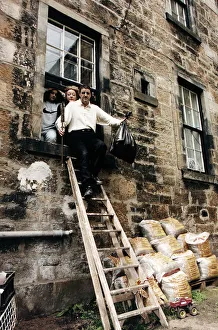 Iain McColl actor with family climbing out window down ladders Iain McColl actor with family climbing out window down ladders