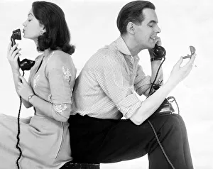 Ian Carmichael and Janette Scott on the telephone, he is holding the wedding rings Ian Carmichael and Janette Scott on the telephone, he is holding the wedding rings