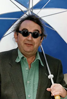 Ian McCaskill wearing a pair of Debenhams Mondo Sunglasses holding umbrella Ian McCaskill wearing a pair of Debenhams Mondo Sunglasses holding umbrella