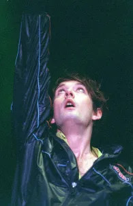 Jarvis Cocker of pop group Pulp on stage at T in the Park on Sunday with arm raised in Jarvis Cocker of pop group Pulp on stage at T in the Park on Sunday with arm raised in