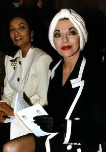 Joan Collins Actress and Shakira Caine sit side by side at a fashion show in London Joan Collins Actress and Shakira Caine sit side by side at a fashion show in London