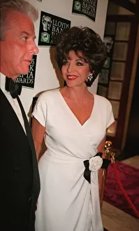 Joan Collins arriving BAFTA Awards 1996 accompanied by man wearing bow tie Joan Collins arriving BAFTA Awards 1996 accompanied by man wearing bow tie