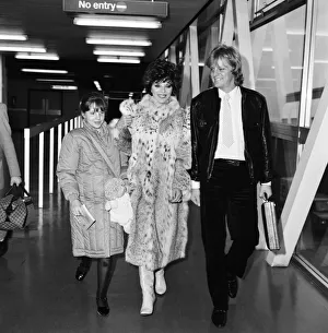 Joan Collins with daughter Katyana Kass and boyfriend Peter Holm at Heathrow after Joan Collins with daughter Katyana Kass and boyfriend Peter Holm at Heathrow after