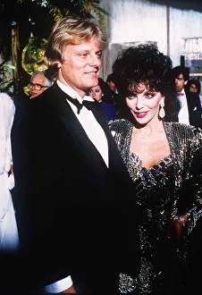 Joan Collins with her new man Malcolm Frazer at a film Premiere at the Odeon Leicester Joan Collins with her new man Malcolm Frazer at a film Premiere at the Odeon Leicester