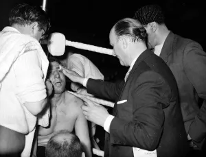 Joe Erskin has the doctor check out his cut eye during his fight with Brian London in Joe Erskin has the doctor check out his cut eye during his fight with Brian London in