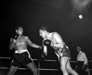 Joe Erskin of Wales throws a right at American Willie Pastrano when they met on the 24th Joe Erskin of Wales throws a right at American Willie Pastrano when they met on the 24th
