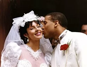 Images Dated 22nd June 1991: John Barnes and his bride Suz, both dressed in white, share a kiss after their wedding