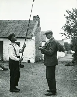 John Barrett and boatman Dick Burke enjoy a 'tall: fishing story together circa 1947 John Barrett and boatman Dick Burke enjoy a 'tall: fishing story together circa 1947