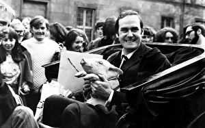 John Cleese at St Andrews ready for a drive around with a piglet John Cleese at St Andrews ready for a drive around with a piglet