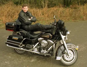 John Gordon Sinclair actor with his feet up on his Harley Davidson Electra Glide John Gordon Sinclair actor with his feet up on his Harley Davidson Electra Glide