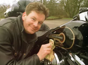 John Gordon Sinclair actor polishing his Harley Davidson Electra Glide motorcycle John Gordon Sinclair actor polishing his Harley Davidson Electra Glide motorcycle
