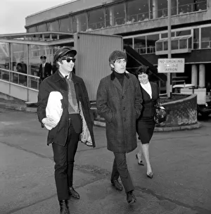 John Lennon and George Harrison of the Beatles pop group at the airport before leaving John Lennon and George Harrison of the Beatles pop group at the airport before leaving