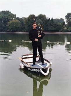John Leslie TV Presenter standing in a rowing boat wearing a tartan suit John Leslie TV Presenter standing in a rowing boat wearing a tartan suit