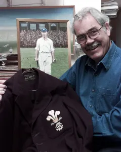 John McKenzie who run a shop of Cricket Memorabilia holds a jacket which was worn by Jack John McKenzie who run a shop of Cricket Memorabilia holds a jacket which was worn by Jack