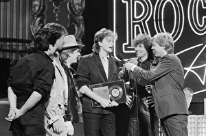 John Taylor, bass player with Duran Duran, receives an award from DJ Kid Jensen John Taylor, bass player with Duran Duran, receives an award from DJ Kid Jensen