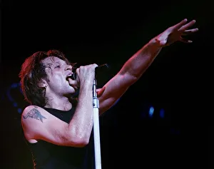 Jon Bon Jovi lead singer of rock group Bon Jovi raises his hand to the audience while Jon Bon Jovi lead singer of rock group Bon Jovi raises his hand to the audience while